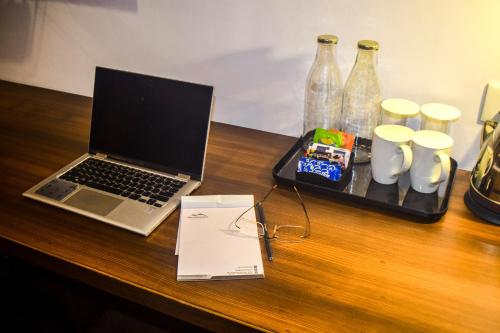a laptop computer sitting on top of a wooden table at Oro Montana Hotels and Resort in Gangtok