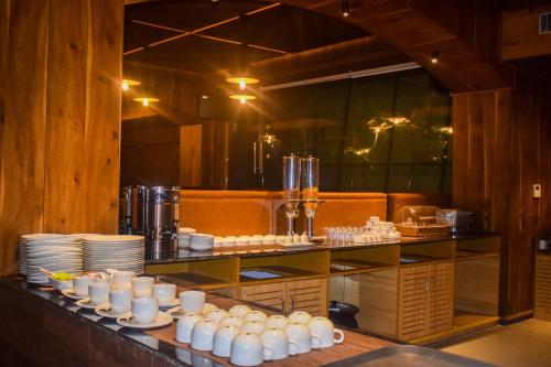 a kitchen with white cups and plates on a counter at Oro Montana Hotels and Resort in Gangtok