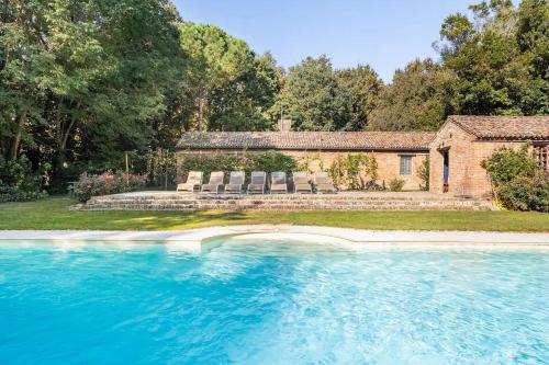 a house with a swimming pool in front of a house at Agriturismo Tenuta Castel Venezze in San Martino di Venezze