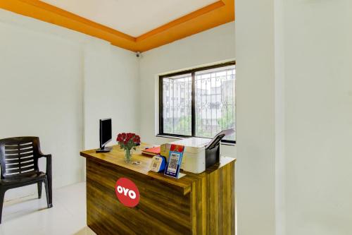 a room with a wooden desk with a window at Flagship Ap Royal Rooms in Nagpur