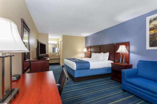 a hotel room with a bed and a desk at Days Inn by Wyndham Chipley in Chipley