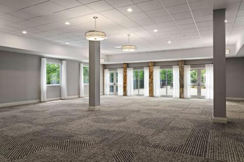 a large room with columns and windows in a building at DoubleTree by Hilton Pittsburgh Airport in Moon Township
