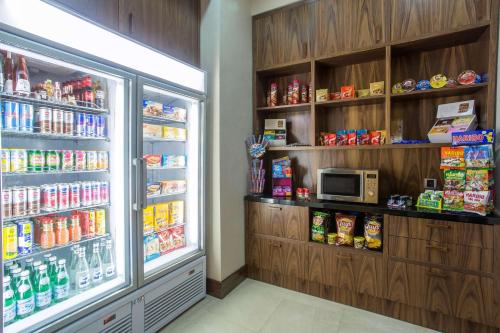 a store aisle with a refrigerator and a microwave at Hilton Garden Inn Tanger City Center in Tangier
