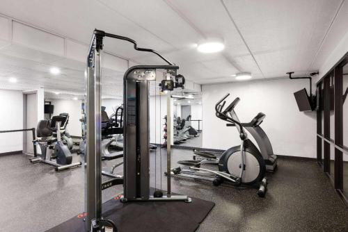 a gym with several treadmills and exercise bikes at Baymont by Wyndham Shakopee in Shakopee