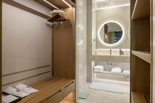 a bathroom with a sink and a mirror at Hyatt Regency Izmir IstinyePark in İzmir