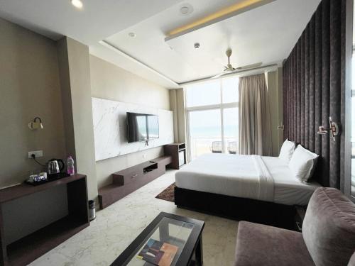 a hotel room with a bed and a tv at Hotel TBS sea view ! Puri Swimming-pool, fully-air-conditioned-hotel with-lift-and-parking-facility breakfast-included in Puri