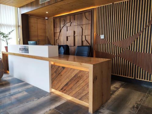 an office with a wooden desk with two chairs at Oro Montana Hotels and Resort in Gangtok