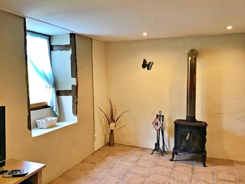 a living room with a wood stove in the corner at Les Verges Gites in Exideuil