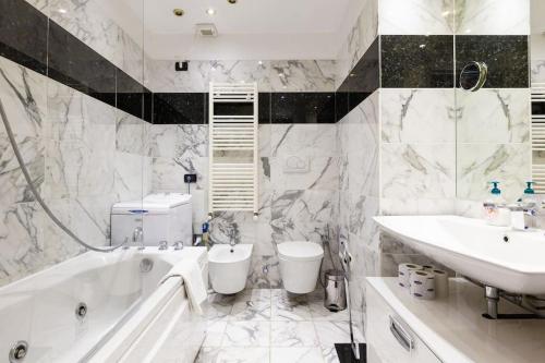 a white bathroom with a tub and a sink and a bath tub at Casa Delle 5 Giornate di Milano in Milan