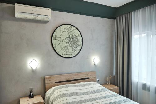 a bedroom with a bed and a clock on the wall at Готель Зірка in Kropyvnytskyi