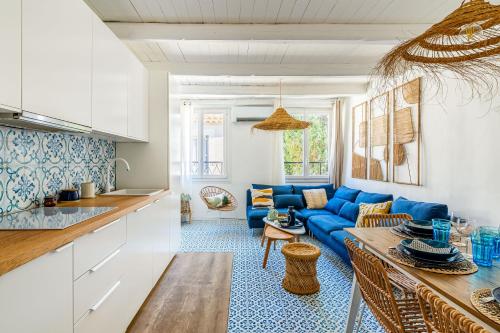 Il comprend une cuisine et un salon doté d'un canapé bleu. dans l'établissement Casa Azul - magnifique duplex coeur historique 4 chambres avec terrasse vue mer, à La Ciotat