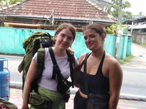 two women standing next to each other on a street at SILVER RAIL in Galle