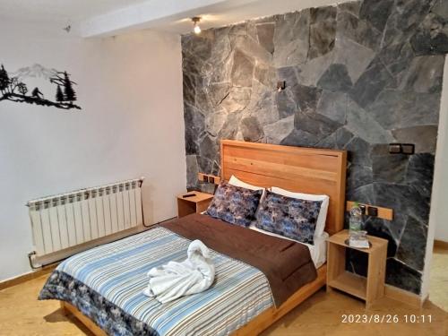 a bedroom with a bed with a person laying on it at Le Gite du Barrage in Zaouia Ben Smine