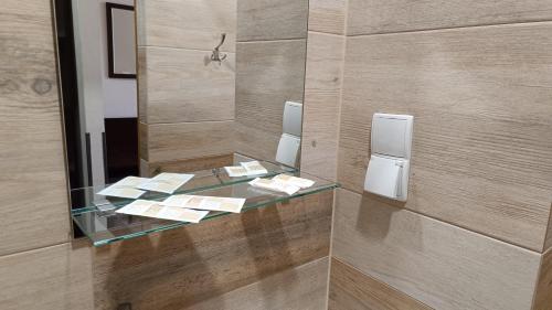 a glass counter in a bathroom with a mirror at Noclegi Gambit Cieszyn 24h in Cieszyn