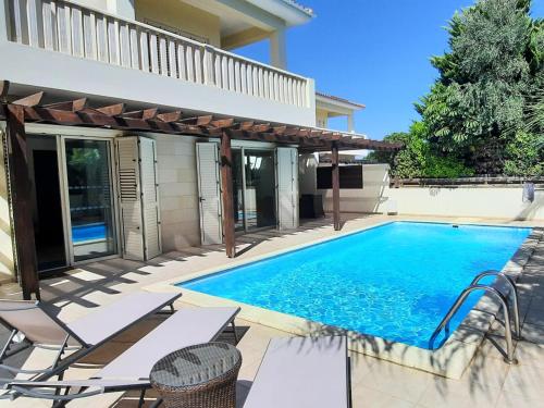 a swimming pool in the backyard of a house at Villa Larnaca Bay Resort in Oroklini