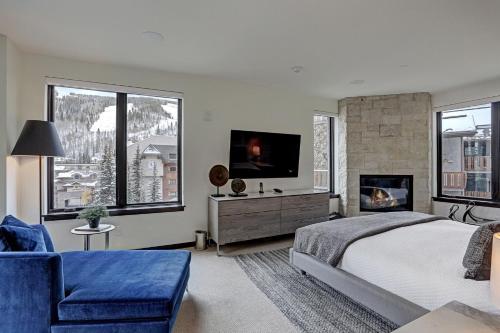 a bedroom with a large bed and a fireplace at The Arrabelle at Vail Square, a RockResort in Vail