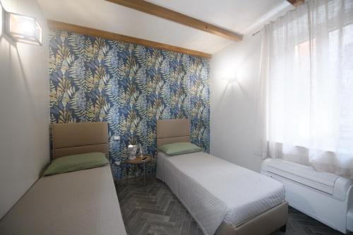 Postel nebo postele na pokoji v ubytování Vicolo d'Este