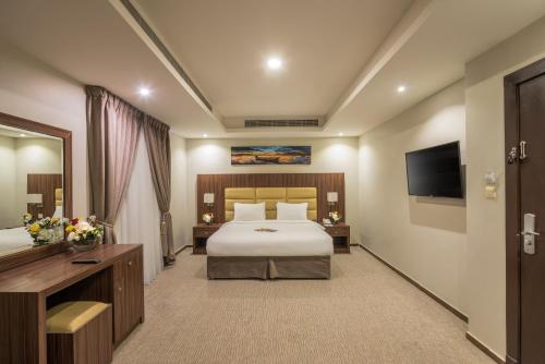 Postel nebo postele na pokoji v ubytování Myrtle Hotel Al Shohadaa