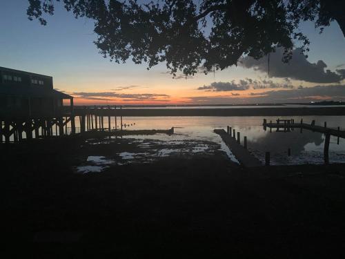 a sunset over a body of water with a dock at Legend oaks sportsman package in Gautier