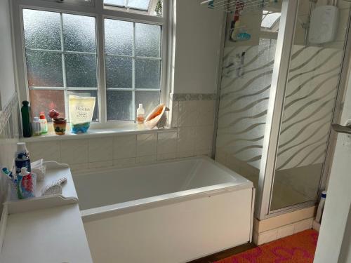 a white bath tub in a bathroom with a window at 32 