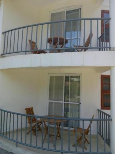 a balcony with chairs and a table on a porch at HOTEL HIPPO BUCK in Homa Bay