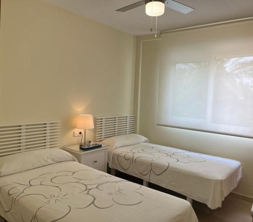 a room with two beds and a window at ÁTICO - Playa Paraíso - Cabo de Palos - La Manga - VV MU3896 in Cabo de Palos