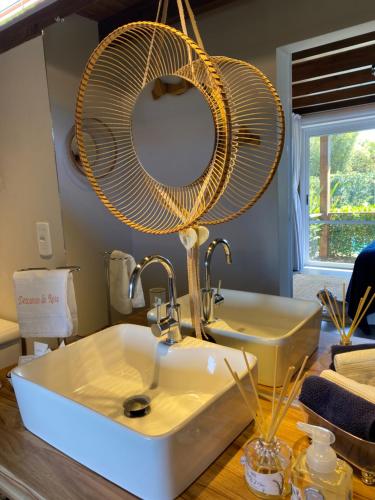 a bathroom with a sink and a fan at Descanso do Rosa - cabanas charmosas in Imbituba