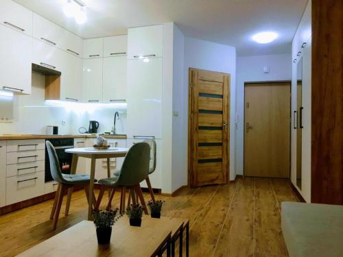 a kitchen with a table and chairs in a room at Bounty in Busko-Zdrój