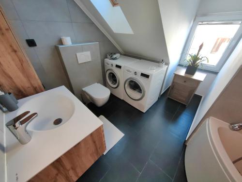 a bathroom with a washing machine and a sink at Sana in Postojna