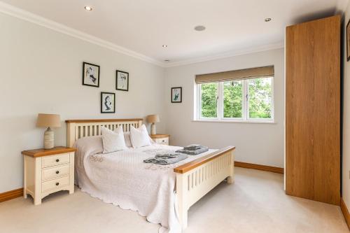 a bedroom with a bed and a window at Woodland Cottage by inspirestays-com in Duneton