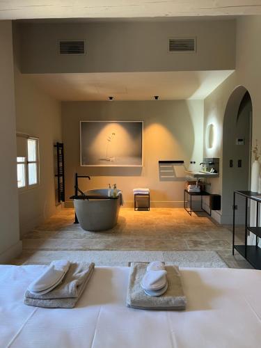 a large bathroom with a tub and a sink at Hotel La Bastide d'Eygalières in Eygalières