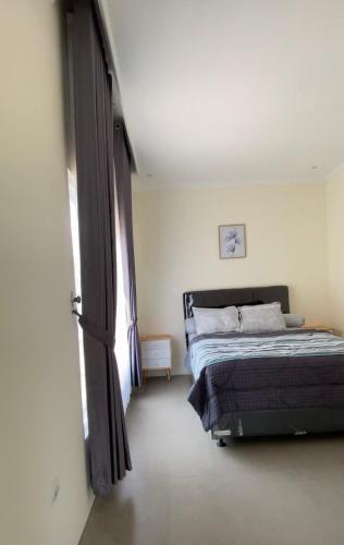 a bedroom with a bed and a large window at Villa Orion Sundak in Tepus