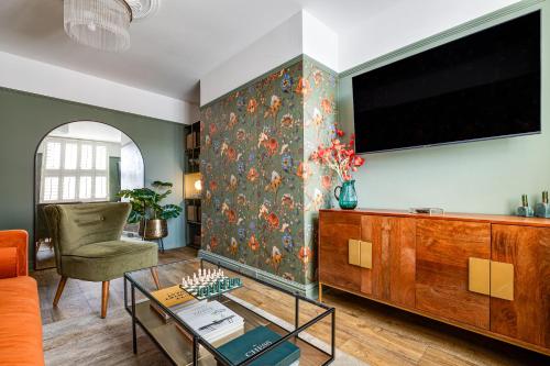 a living room with a flat screen tv on a wall at Insta-worthy Loft on Historic Chester Rows, Sleeps 4 & Free Parking in Chester