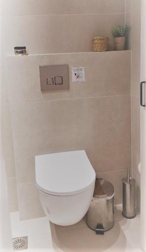 a bathroom with a white toilet in a room at Calmare suites in Rethymno Town