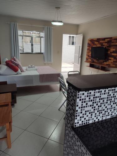 a room with a bed and a table and chairs at Hotel Lumiar in Lumiar