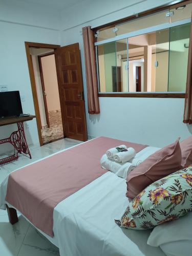 a bedroom with two beds and a mirror at Hotel Lumiar in Lumiar