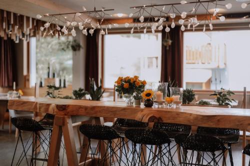 a large wooden table with chairs around it at Apart Lodge belMont in Saas-Fee
