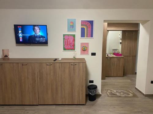 a room with a flat screen tv on a wall at MareLuna Guest House in Naples