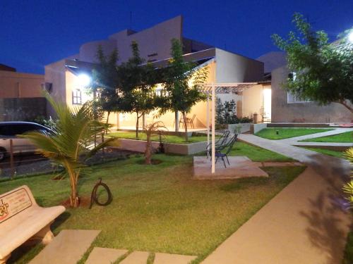a house with a garden in front of it at night at Hotel Winner in Barretos