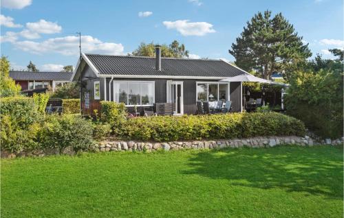 a small house with a green lawn in front of it at Nice Home In Vordingborg With Wifi in Vordingborg