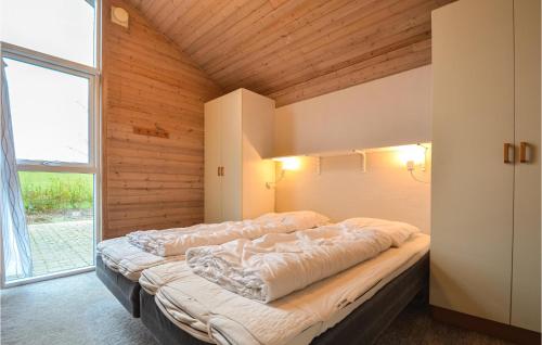 KnebelにあるPet Friendly Home In Knebel With Indoor Swimming Poolの大きな窓付きの客室の大型ベッド1台分です。