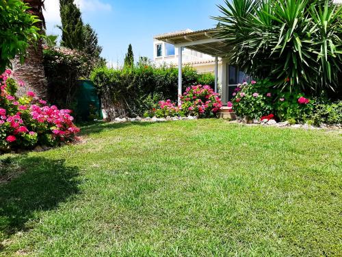 a yard with colorful flowers and a house at CORAL BAY suite Cyprus in Coral Bay