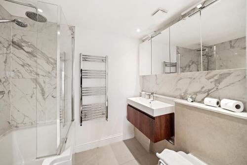 a bathroom with a sink and a shower at Monthly Stays! 2 Bed Stunning Riverside Apartment in London
