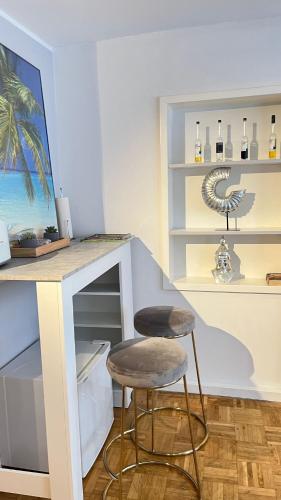 a bar with a stool and a counter with wine bottles at Gemütliche Wohnung in Trier Fußgängerzone in Trier