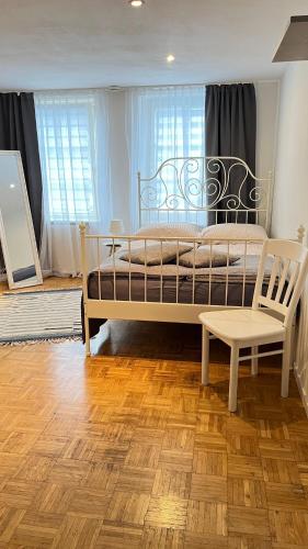 特里爾的住宿－Gemütliche Wohnung in Trier Fußgängerzone，一间卧室配有一张床、一张长凳和一把椅子