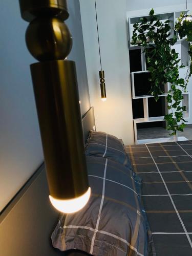 a lamp hanging over a bed in a room at Apartments Black Sea in Odesa