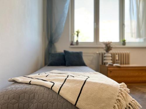 a bedroom with a bed with a blanket on it at Cozy room near the city centre in Košice