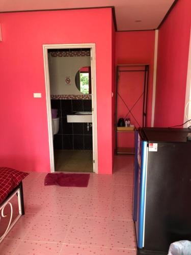 a pink bathroom with a sink and a mirror at ต้นกล้า รีสอร์ท 