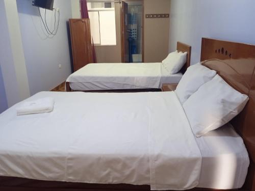 Een bed of bedden in een kamer bij Hospedaje Feliz