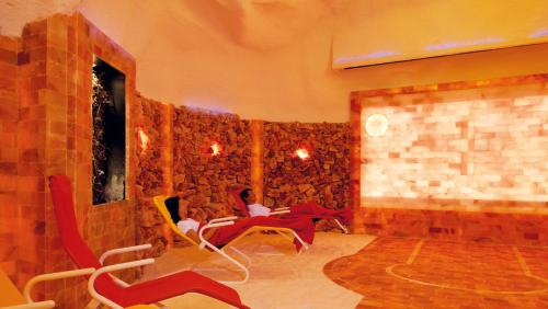 a living room with chairs and a brick wall at Gasthof Post in Dalaas